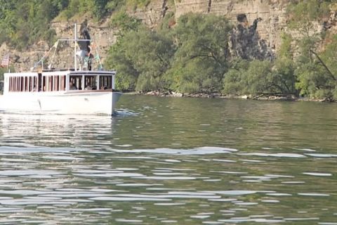 Boat on water in front of mountain