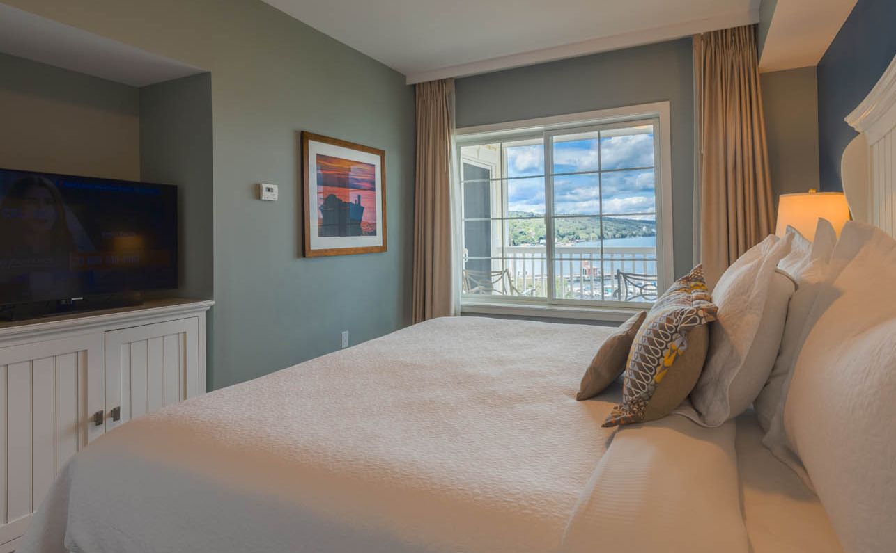 A king bedroom in a Lake View Suite, featuring a fabulous view of Seneca Lake