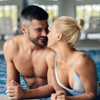Affectionate couple flirting in the pool at our hotel.