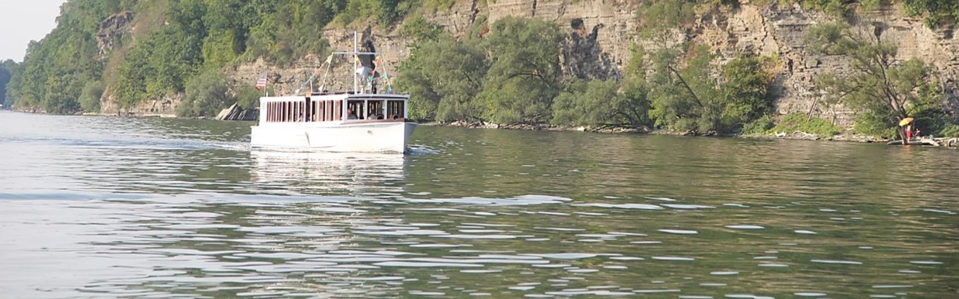 Boat on water in front of mountain
