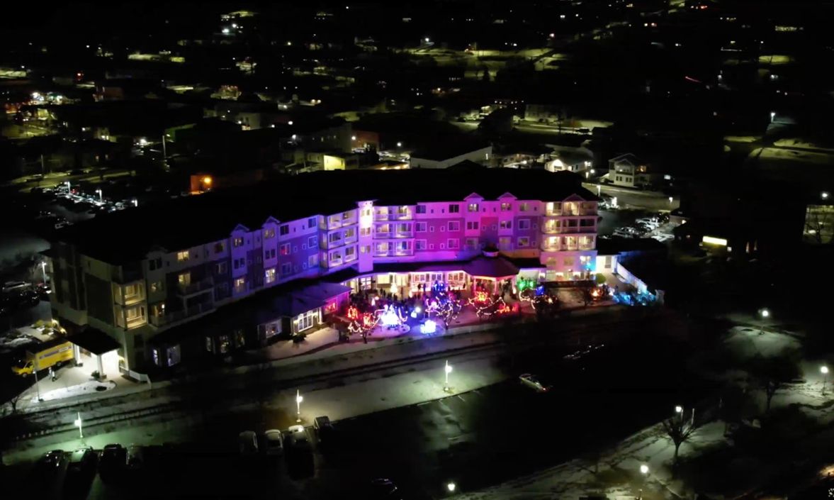 An aerial image of the Watkins Glen Harbor Hotel lit in colorful lights for the Fire and Ice celebration